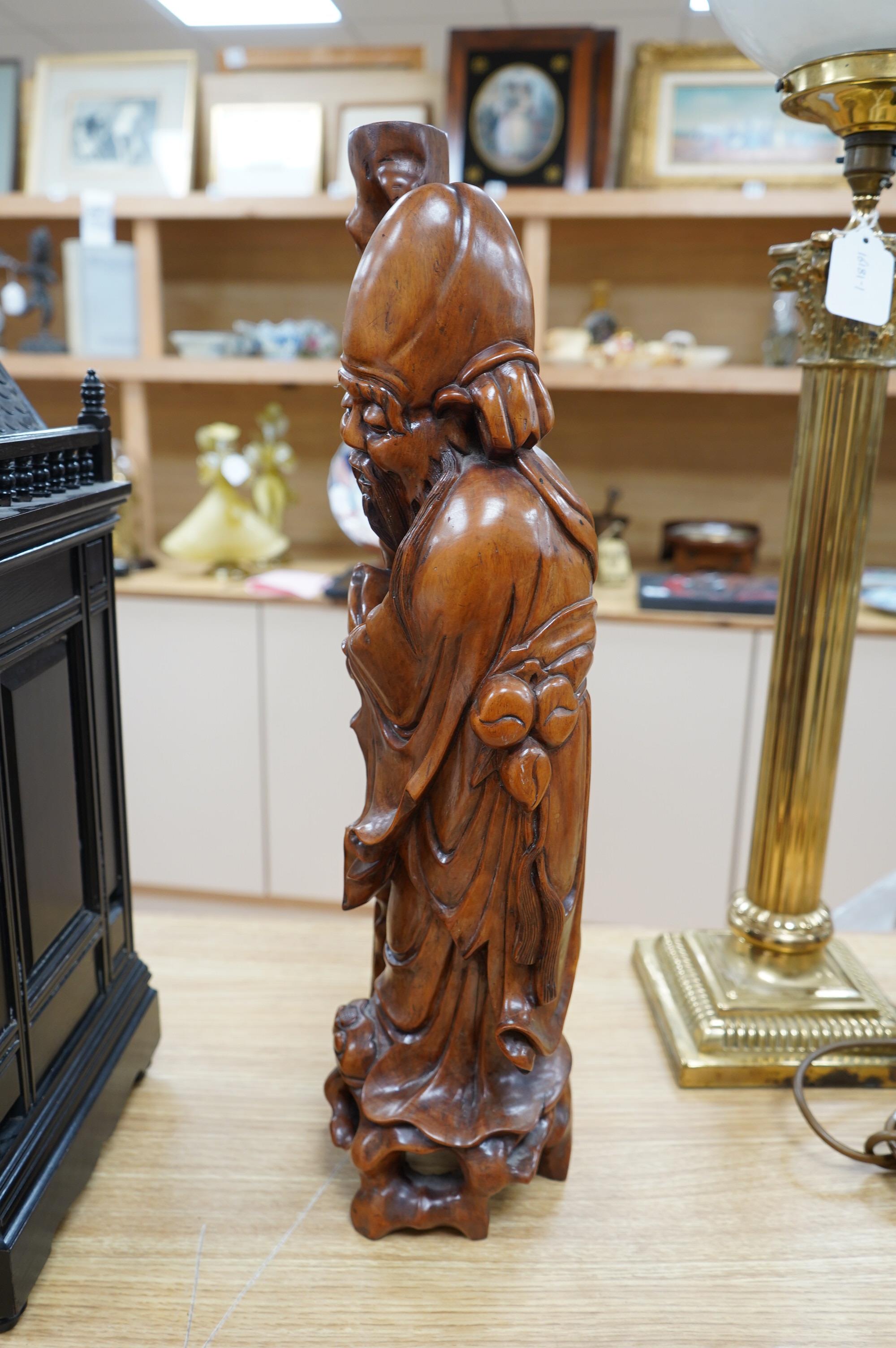 An early 20th century Chinese carved hardwood figure of Shou Lao, mounted as a lamp base, 55cm high. Condition - good